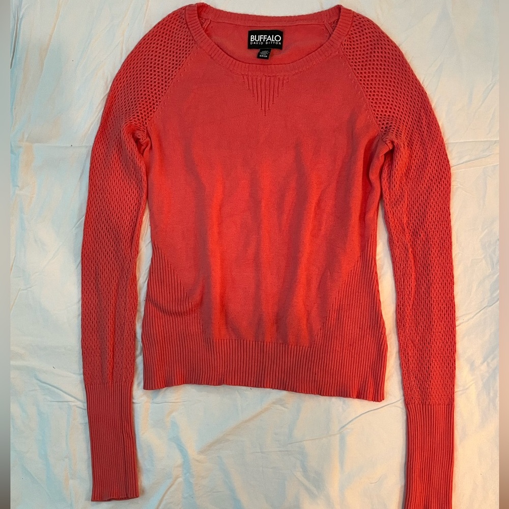 Red-orange sweater with fishnet sleeves